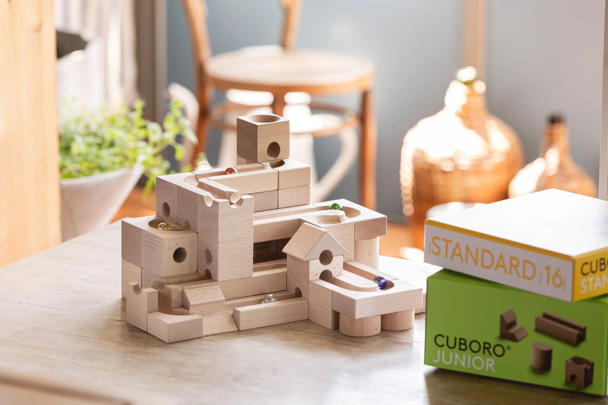 JUMP - Add thrilling leaps and daring jumps to your CUBORO marble runs with the JUMP Extra Set! This exciting wooden educational toy includes 12 elements and 3 marbles, featuring unique trampoline-like pieces that allow marbles to jump over obstacles and