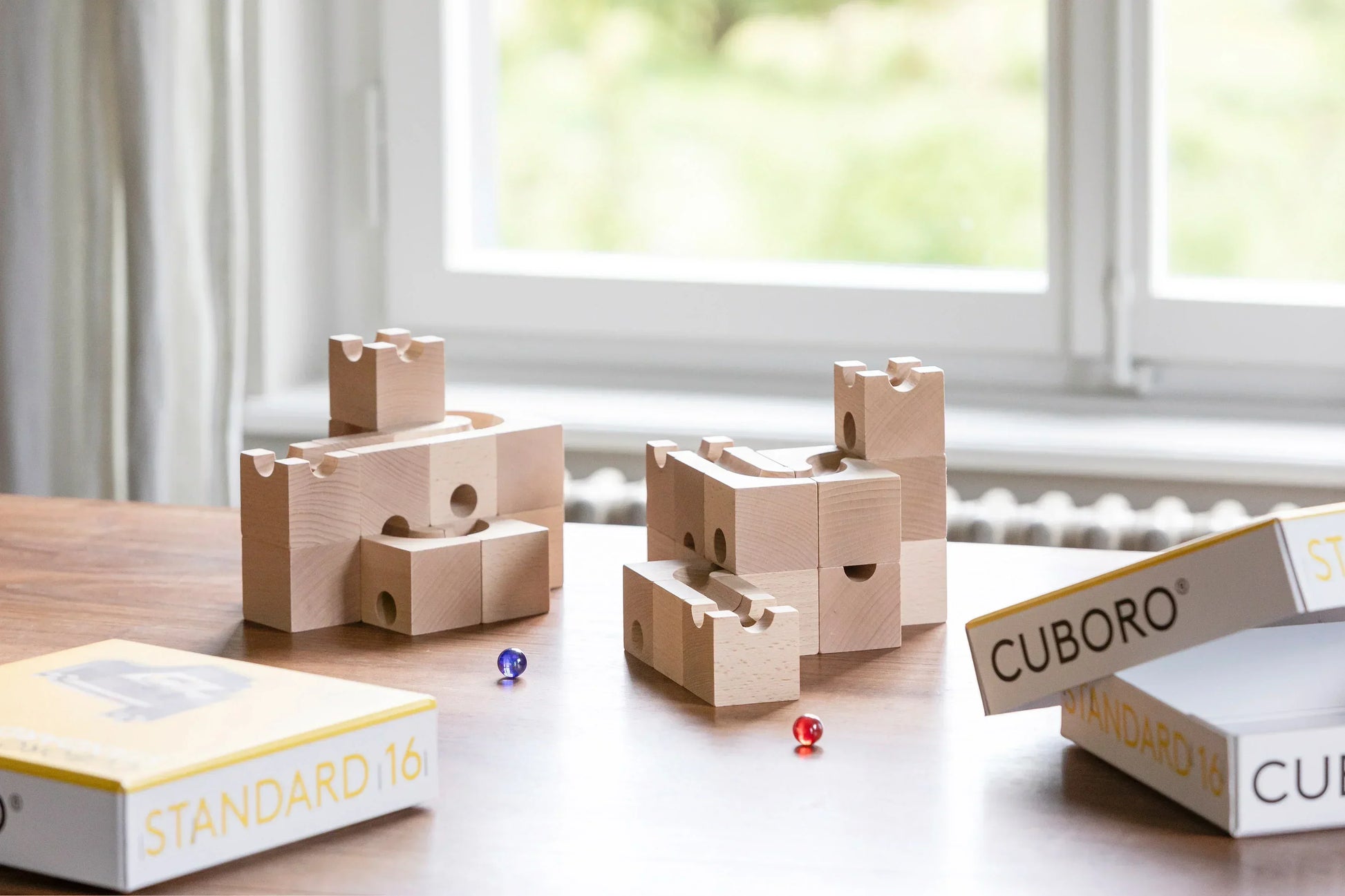JUMP - Add thrilling leaps and daring jumps to your CUBORO marble runs with the JUMP Extra Set! This exciting wooden educational toy includes 12 elements and 3 marbles, featuring unique trampoline-like pieces that allow marbles to jump over obstacles and