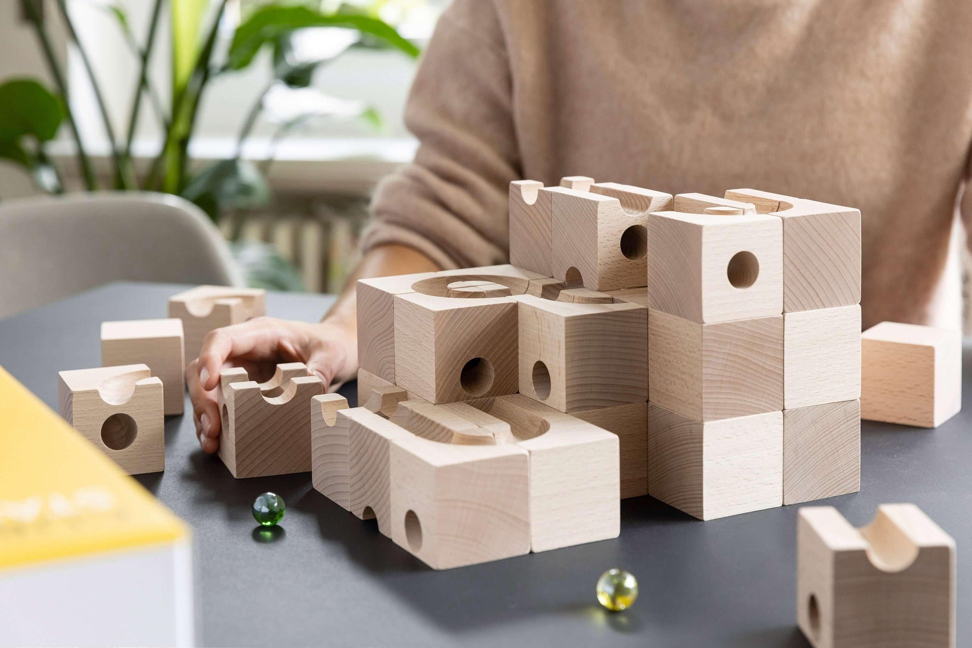 TRICK - Introduce an element of delightful unpredictability to your CUBORO marble runs with the TRICK Extra Set! This captivating wooden educational toy includes 16 elements and 5 marbles, designed to bring chance into play, causing marbles to take surpri