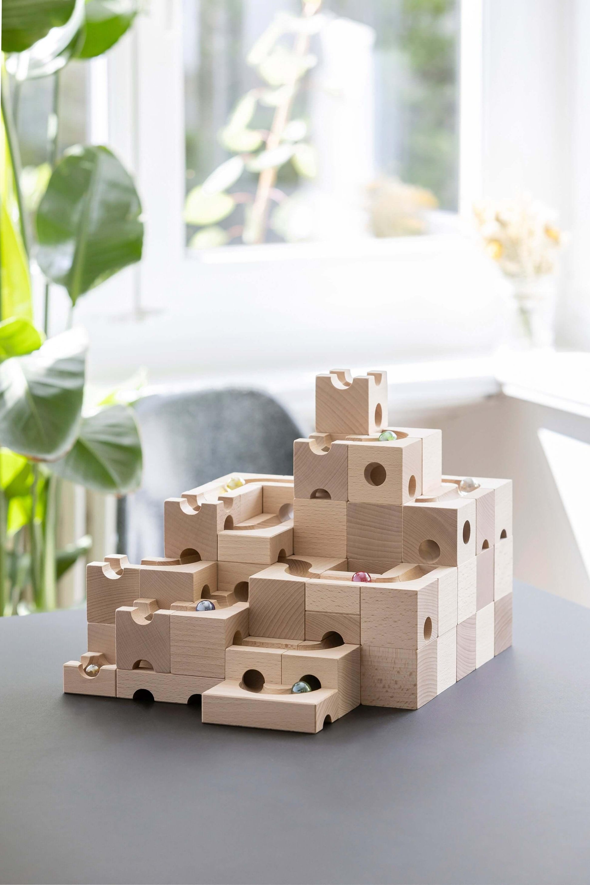 JUMP - Add thrilling leaps and daring jumps to your CUBORO marble runs with the JUMP Extra Set! This exciting wooden educational toy includes 12 elements and 3 marbles, featuring unique trampoline-like pieces that allow marbles to jump over obstacles and