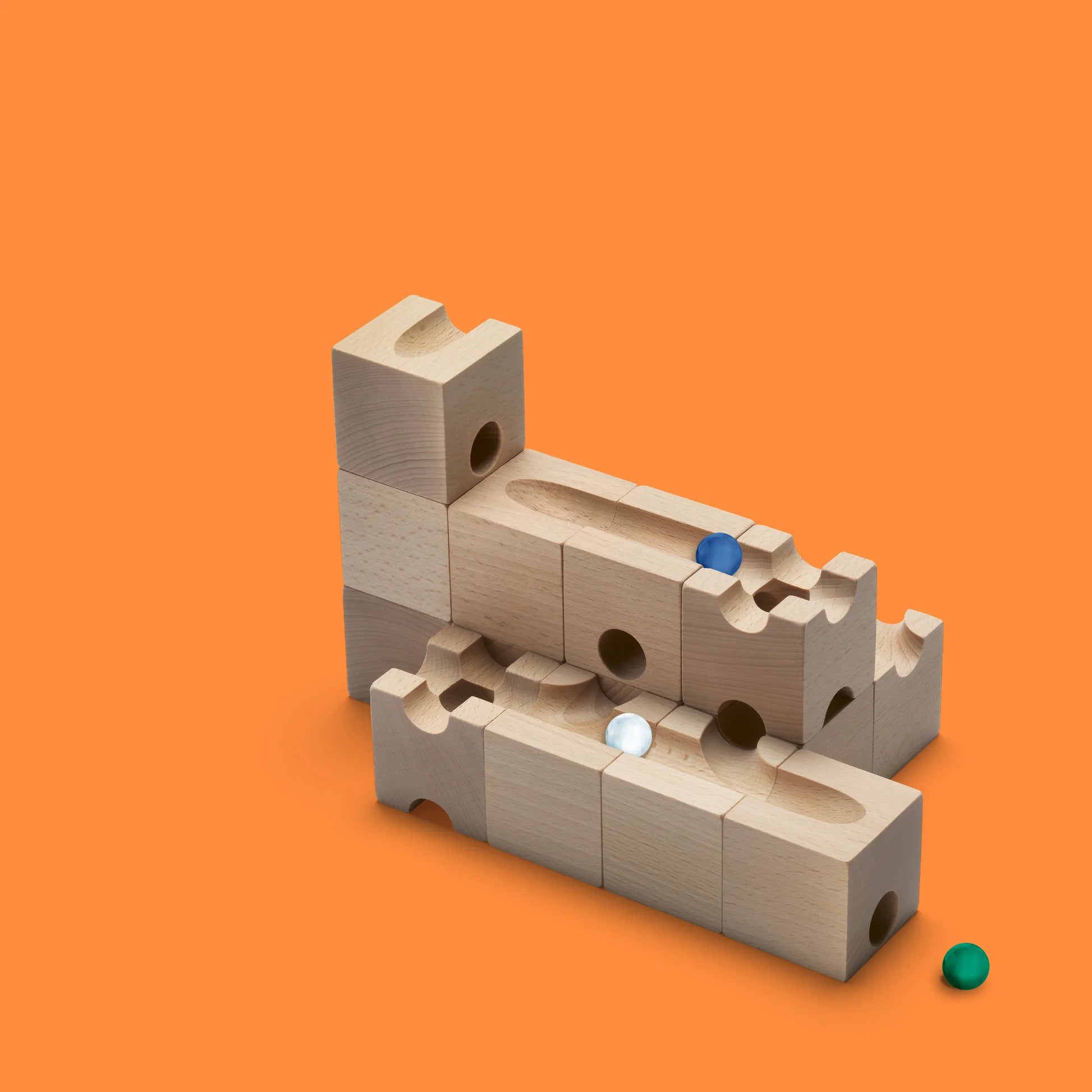 TRICK - Introduce an element of delightful unpredictability to your CUBORO marble runs with the TRICK Extra Set! This captivating wooden educational toy includes 16 elements and 5 marbles, designed to bring chance into play, causing marbles to take surpri